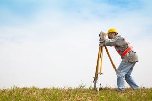 stock-photo-surveyor-engineer-making-measure